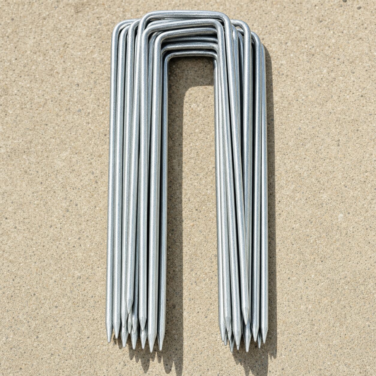 Galvanized steel sod staples in a tight bundle.